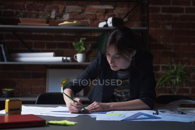 Young female executive working in office — Stock Photo