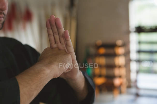 Male fighter training karate stance in fitness studio. — Stock Photo