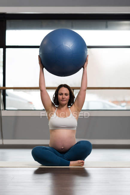 Pregnant woman exercising with exercise ball — Stock Photo
