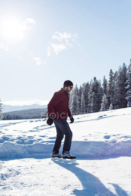 Homem patinando na paisagem nevada durante o inverno . — Fotografia de Stock