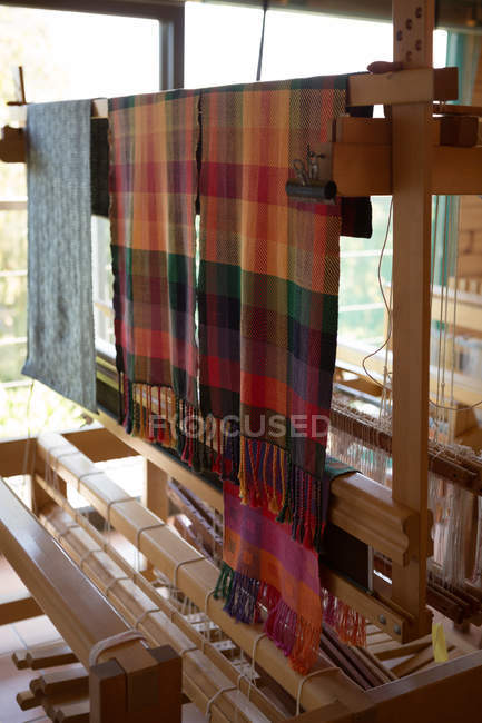 Silk cloth hanging on machine at factory — Stock Photo