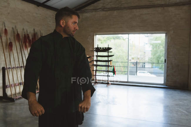 Karate fighter training martial arts in fitness studio. — Stock Photo