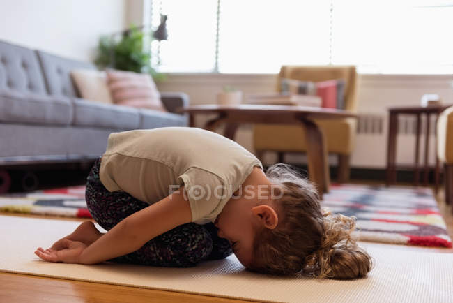 Girl doing meditation in living room at home — Stock Photo