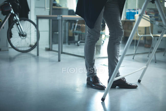 Low section of executive standing in modern office — Stock Photo