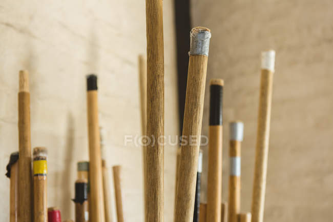 Close-up of long poles arranged in martial arts studio. — Stock Photo