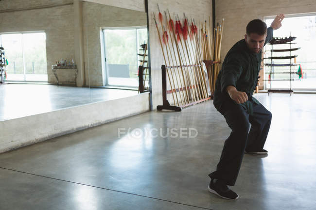 Karate fighter training martial arts in fitness studio. — Stock Photo