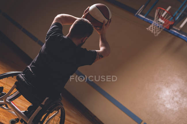 Rear view of disabled man practicing basketball in the court — Stock Photo