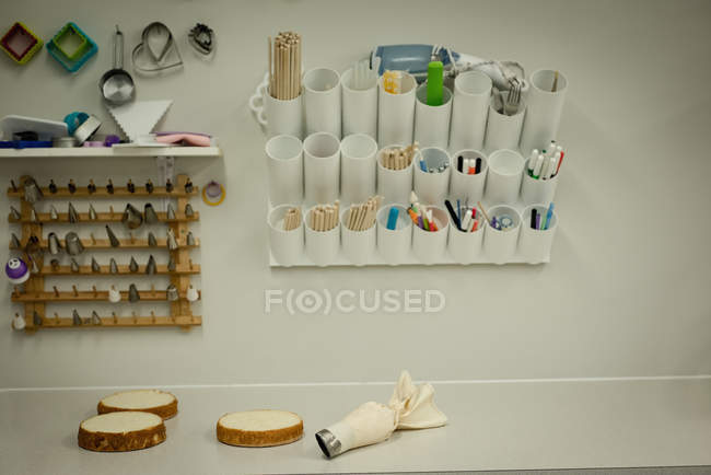 Shortcake on table with various equipment in bakery — Stock Photo