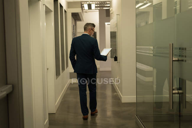 Business executive using digital tablet at office — Stock Photo