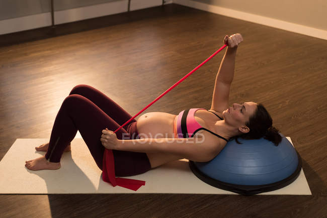 Pregnant woman exercising in living room — Stock Photo