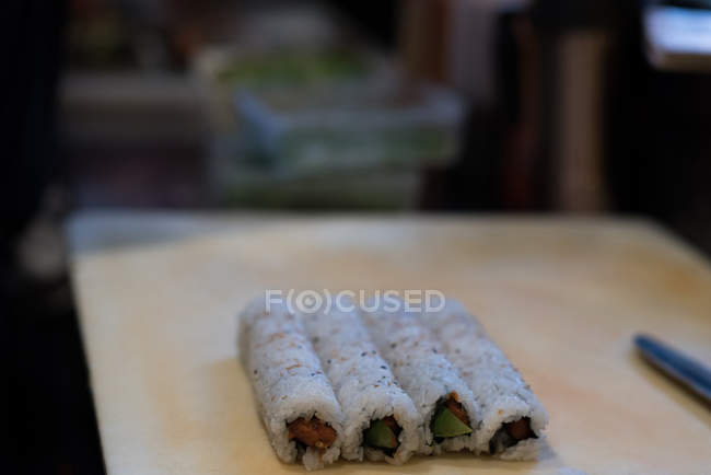 Rolled sushi kept on a table in a restaurant — Stock Photo