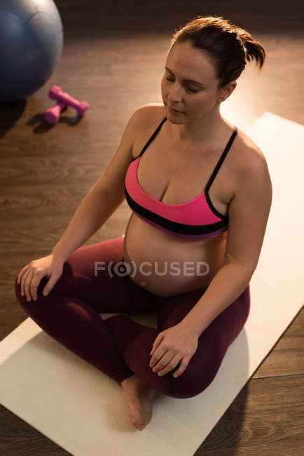 Pregnant woman performing yoga — Stock Photo