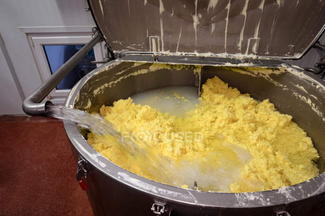Close-up view of water being mixed in batter at factory — Stock Photo