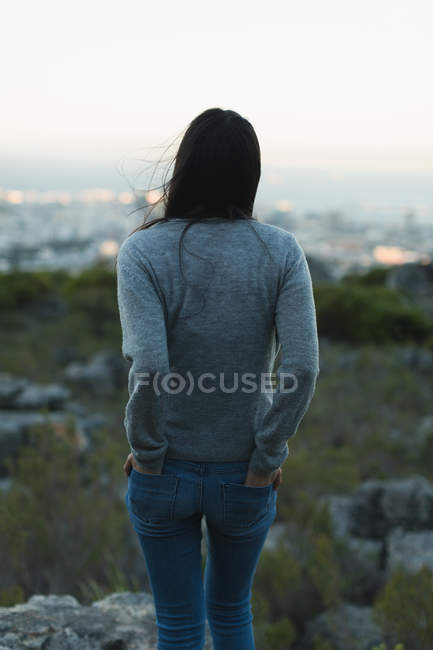 Rear view of woman standing with hand in pockets — Stock Photo
