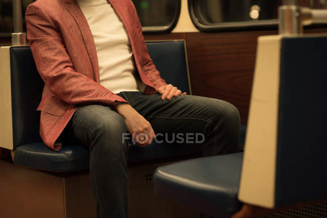 Mid section of man travelling in train — Stock Photo