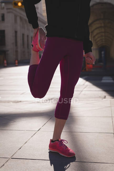 Low section of fit woman warming up at street — Stock Photo