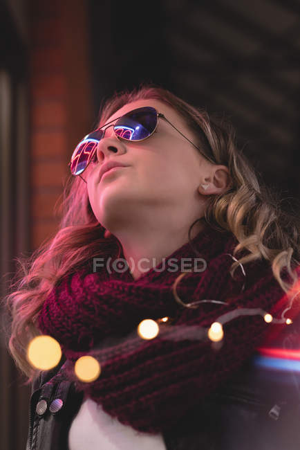 Low angle of beautiful girl standing outside the shopping center — Stock Photo