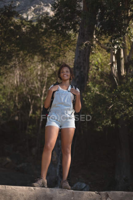 Young female hiker standing with backpack at countryside — Stock Photo