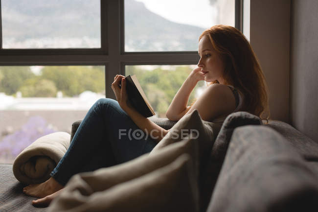 Frau liest zu Hause ein Buch — Stockfoto