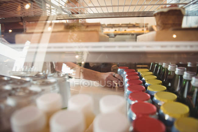 Worker arranging jar at counter in cafeteria — Stock Photo