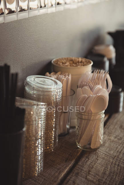Various cutlery and disposable glasses on table in cafe — Stock Photo