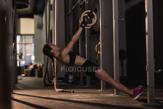 Fit woman exercising with ring in the studio — Stock Photo