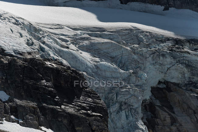 Rock mountain covered with glacier during winter — Stock Photo