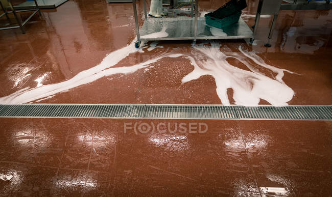 Water overflowing from the tank in food factory — Stock Photo