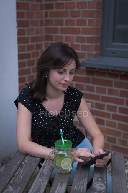 Mujer joven usando el teléfono móvil - foto de stock