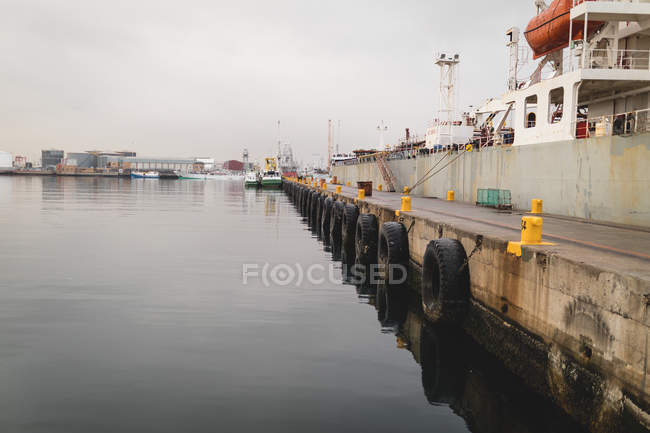 Cargo ships moored in the dockyards at dusk — Stock Photo
