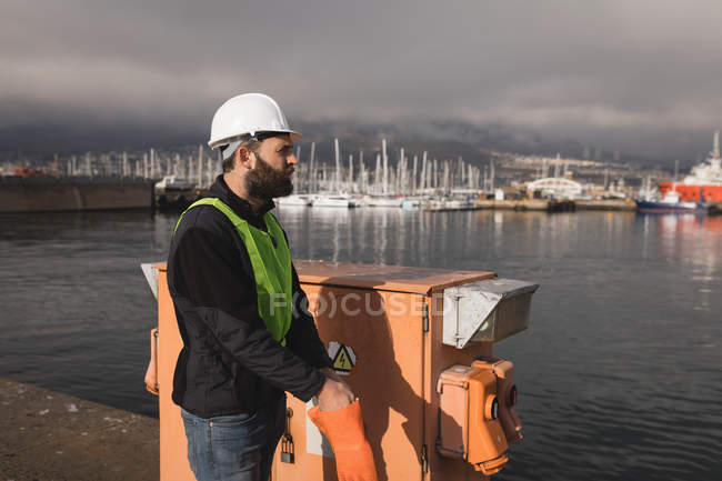 Trabajador portuario con guantes en el astillero en un día soleado - foto de stock