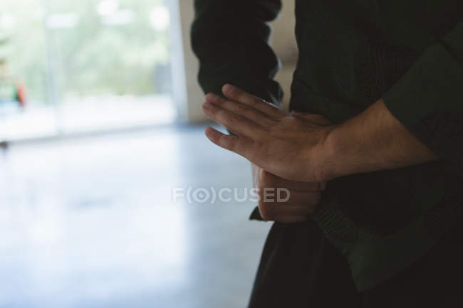 Cropped view of karate fighter practicing martial arts in fitness studio. — Stock Photo