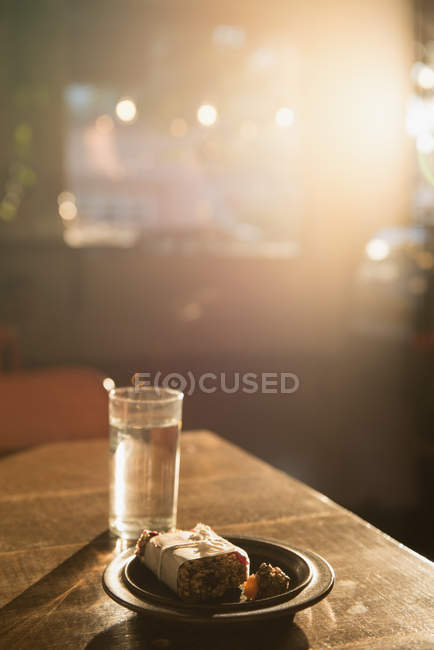 Breakfast and glass of water on table at outdoor cafe — Stock Photo