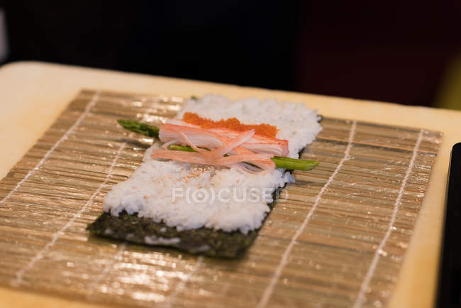 Unrolled sushi kept on a table in a restaurant — Stock Photo