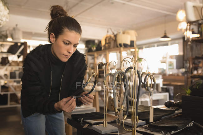 Beautiful woman selecting accessories in boutique shop — Stock Photo