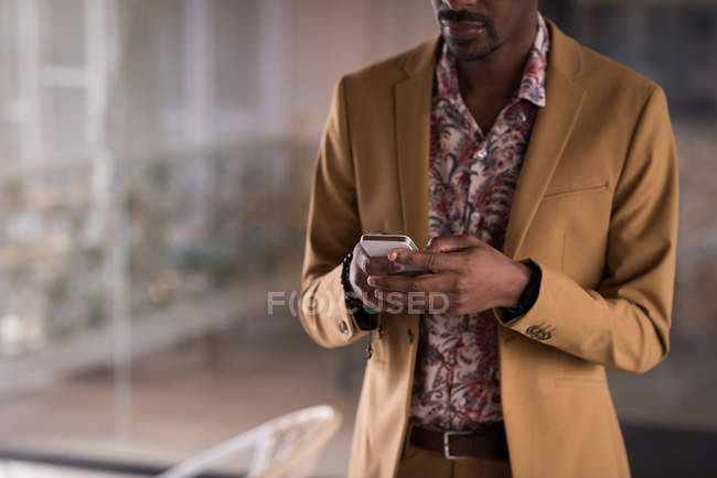 Mid section of businessman using mobile phone in the office — Stock Photo