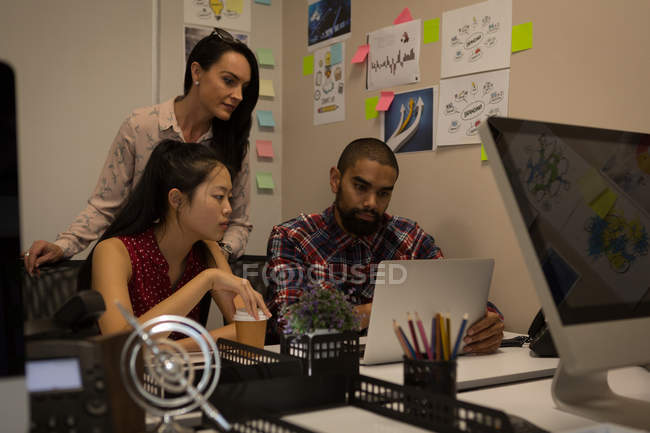 Business colleagues working on laptop at office — Stock Photo
