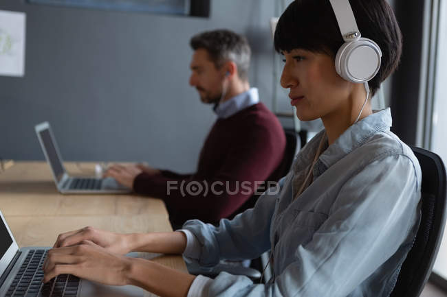 Attentive colleagues working at desk in modern office. — Stock Photo