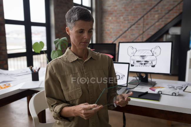 Businesswoman using glass digital tablet in office. — Stock Photo
