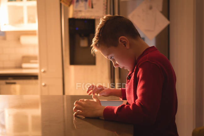 Boy using digital tablet at home — Stock Photo
