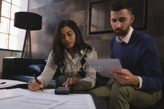 Young business colleagues working with papers at office. — Stock Photo