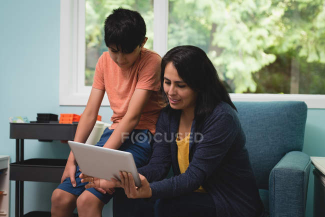 Mother and son having video call on mobile phone at home — Stock Photo