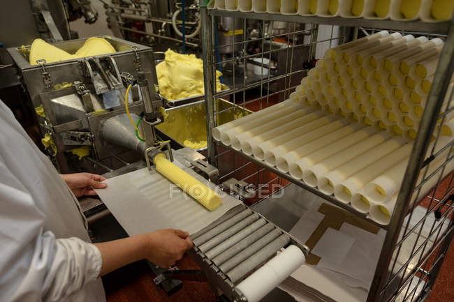 Worker wrapping food rolls in the paper at the factory — Stock Photo