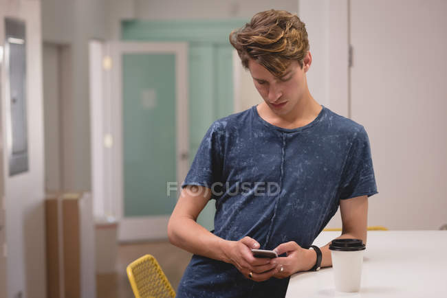 Executive using mobile phone in the creative office — Stock Photo