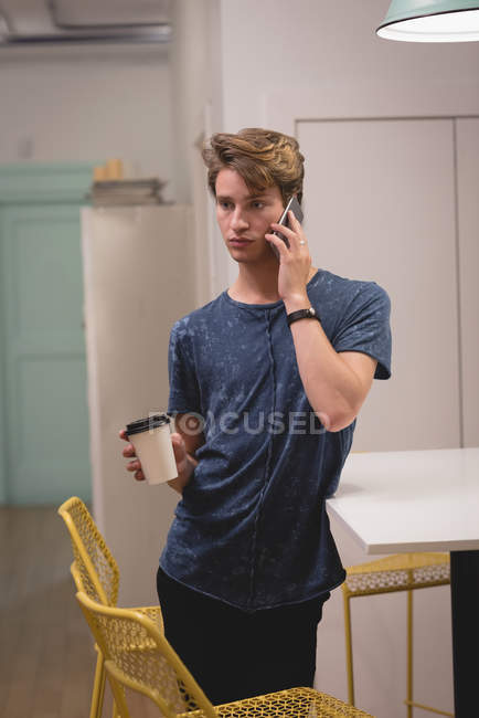 Executive talking on mobile phone in the creative office — Stock Photo