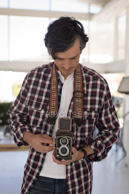 Close-up of photographer taking pictures in the studio — Stock Photo
