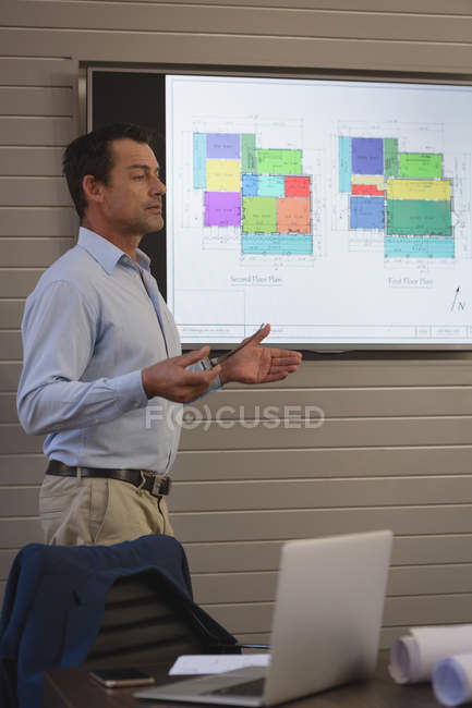 Businessman giving presentation in conference room in office. — Stock Photo