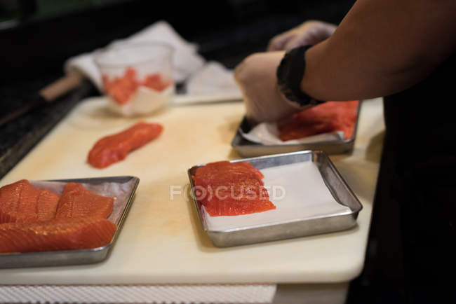 Chef filleting fish in the restaurant kitchen on a chopping board — Stock Photo