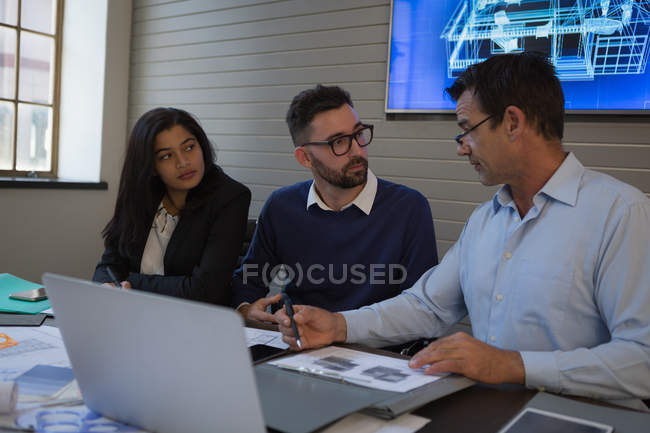 Geschäftsleute diskutieren Bauplan im Besprechungsraum im Büro. — Stockfoto