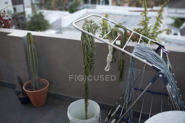 Dyed thread drying on rack in balcony — Stock Photo